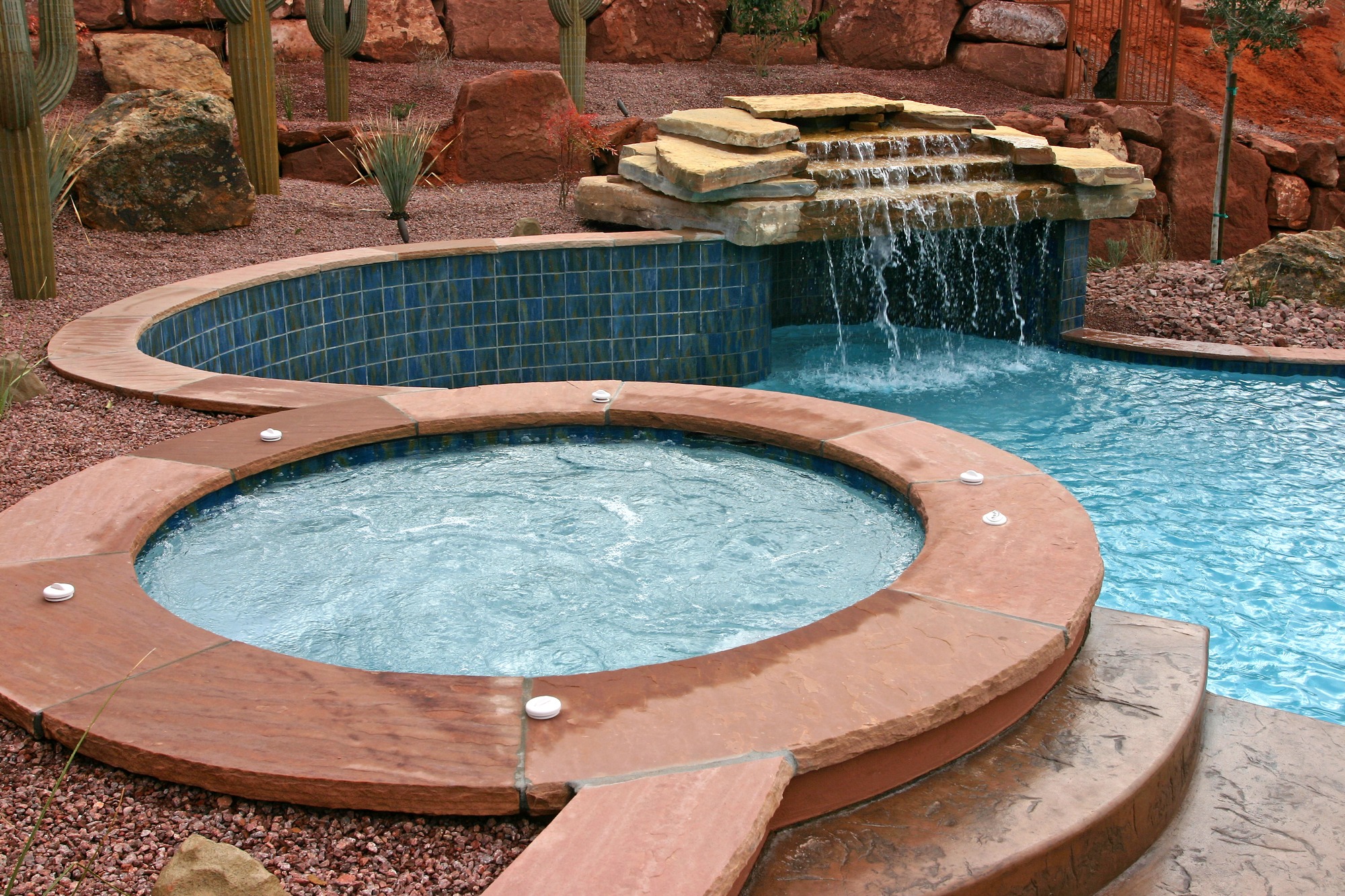 Handsome southwestern style spa and pool graces the backyard of a St. George Utah home