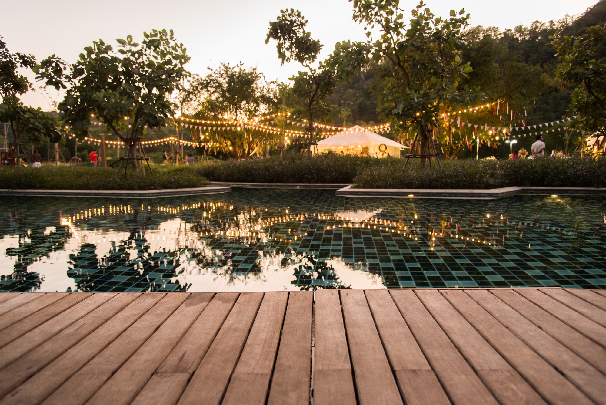 reflection background of camping party with pool at evening time with natural light